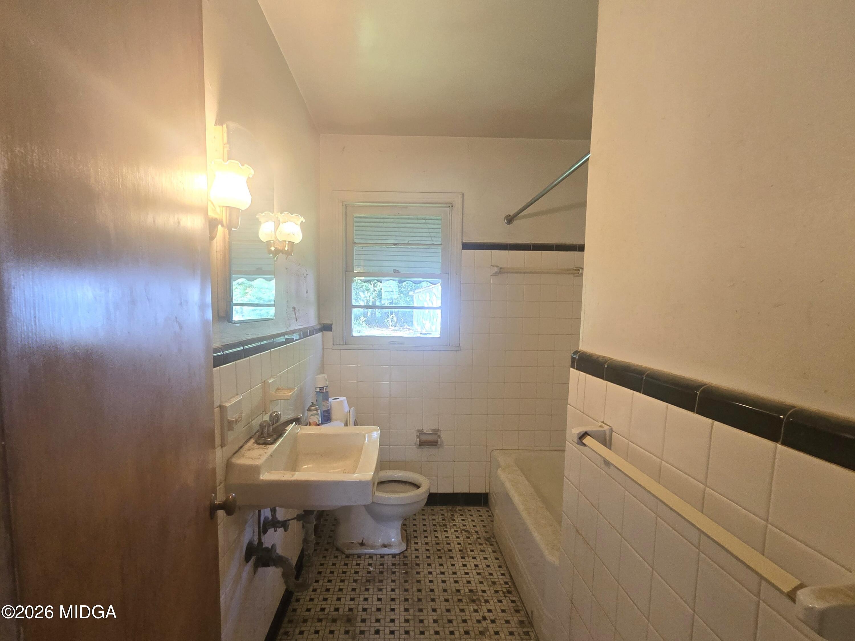 4055 Emory Drive Macon, GA 31206 - Photo 7 of 9 a bathroom with a sink toilet and a mirror