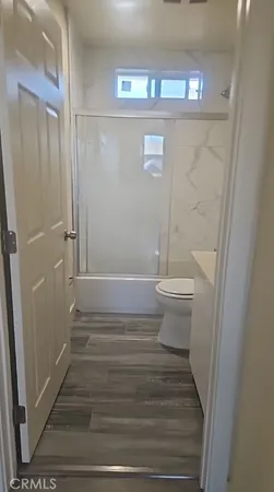 a bathroom with a toilet and a shower