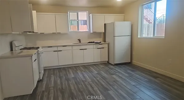 a kitchen with a refrigerator sink and cabinets