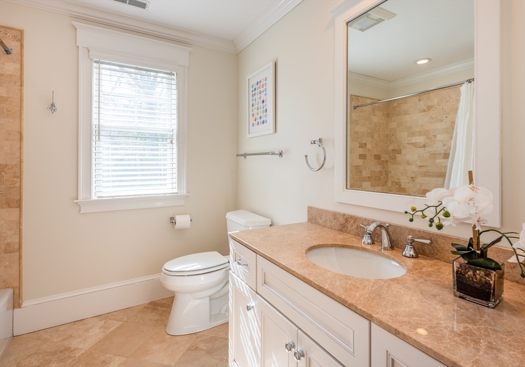 37 Forster Road Manchester, MA 01944 - Photo 32 of 42 a bathroom with a granite countertop sink a large mirror a toilet and a window