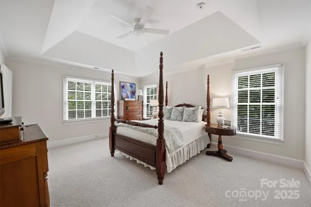 a spacious bedroom with a bed and a window