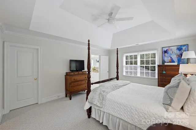 a bedroom with a bed and a television