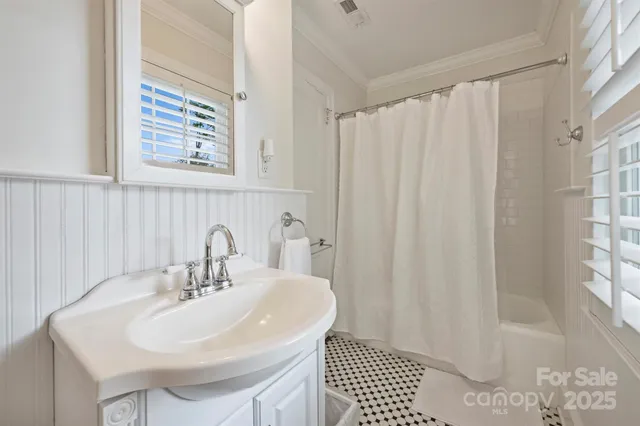 a bathroom with a sink a mirror and a shower