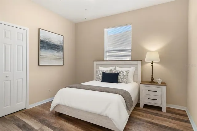 a bedroom with a bed and a night stand