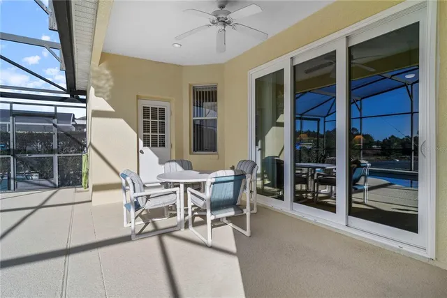 a dining room with furniture and a floor to ceiling window