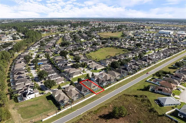 an aerial view of residential houses with outdoor space
