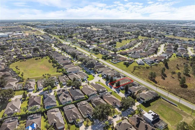 a aerial view of a house with a yard and large trees