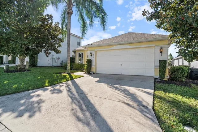 a front view of a house with a garden and yard