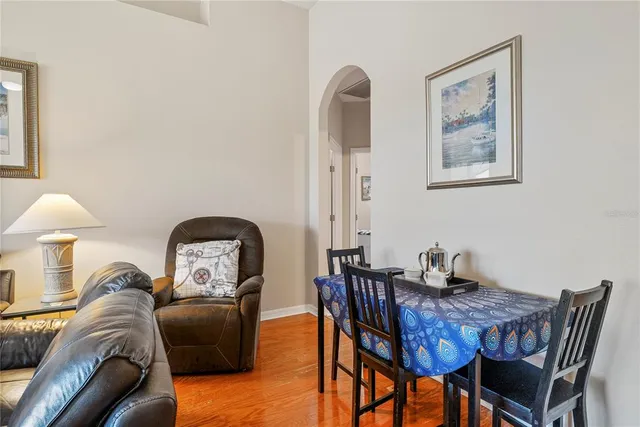 a living room with furniture a couch and a potted plant