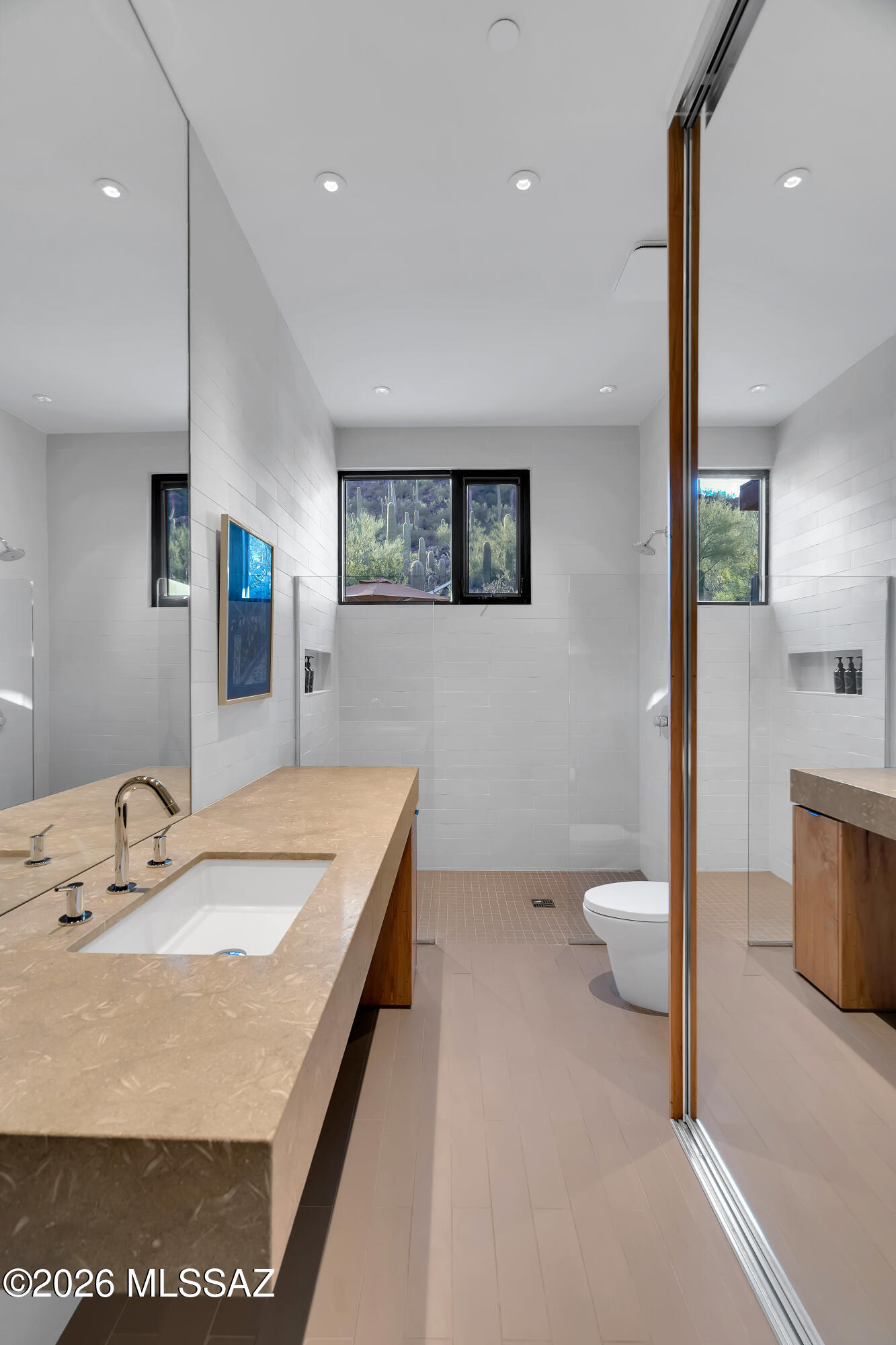 9971 North Silverbell Road Marana, AZ 85653 - Photo 22 of 34 a bathroom with a sink a toilet and a mirror