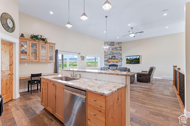 19502 South Olson Road Downey, ID 83234 - Photo 64 of 64 Kitchen featuring glass insert cabinets, light stone countertops, dishwasher, decorative light fixtures, and open floor plan