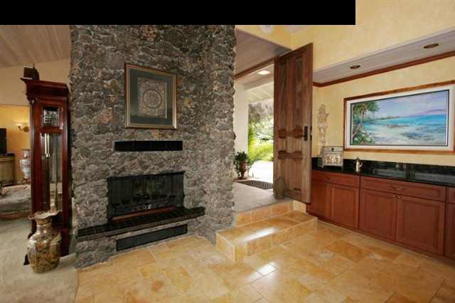 893 Middle Road Kula, HI 96790 - Photo 3 of 24 a living room with stainless steel appliances furniture a fireplace and a flat screen tv