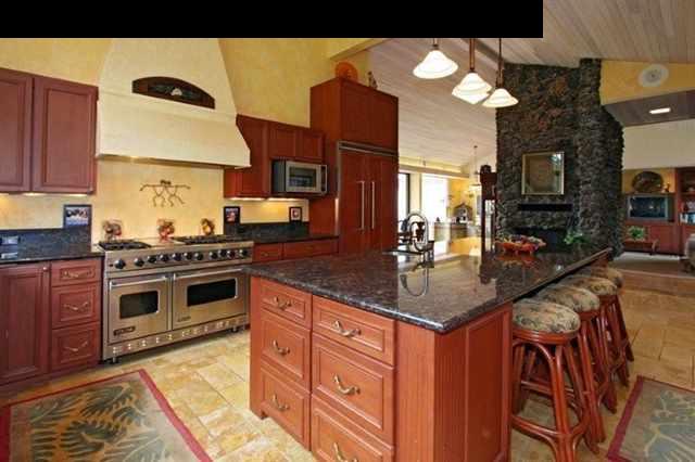 893 Middle Road Kula, HI 96790 - Photo 6 of 24 a kitchen with stainless steel appliances granite countertop a stove a sink and a microwave