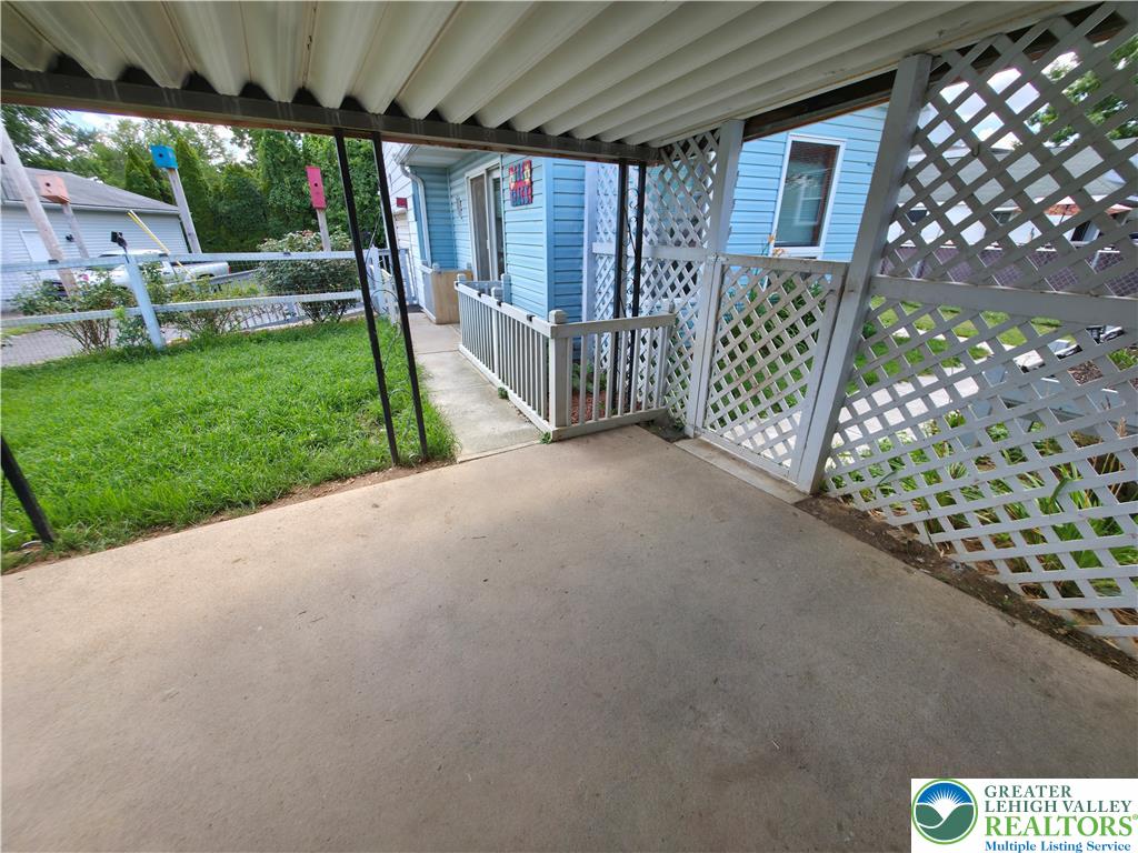 719 Keystone Avenue Bethlehem, PA 18018 - Photo 28 of 32 A well-maintained concrete patio extends from the home, framed by a charming lattice fence.