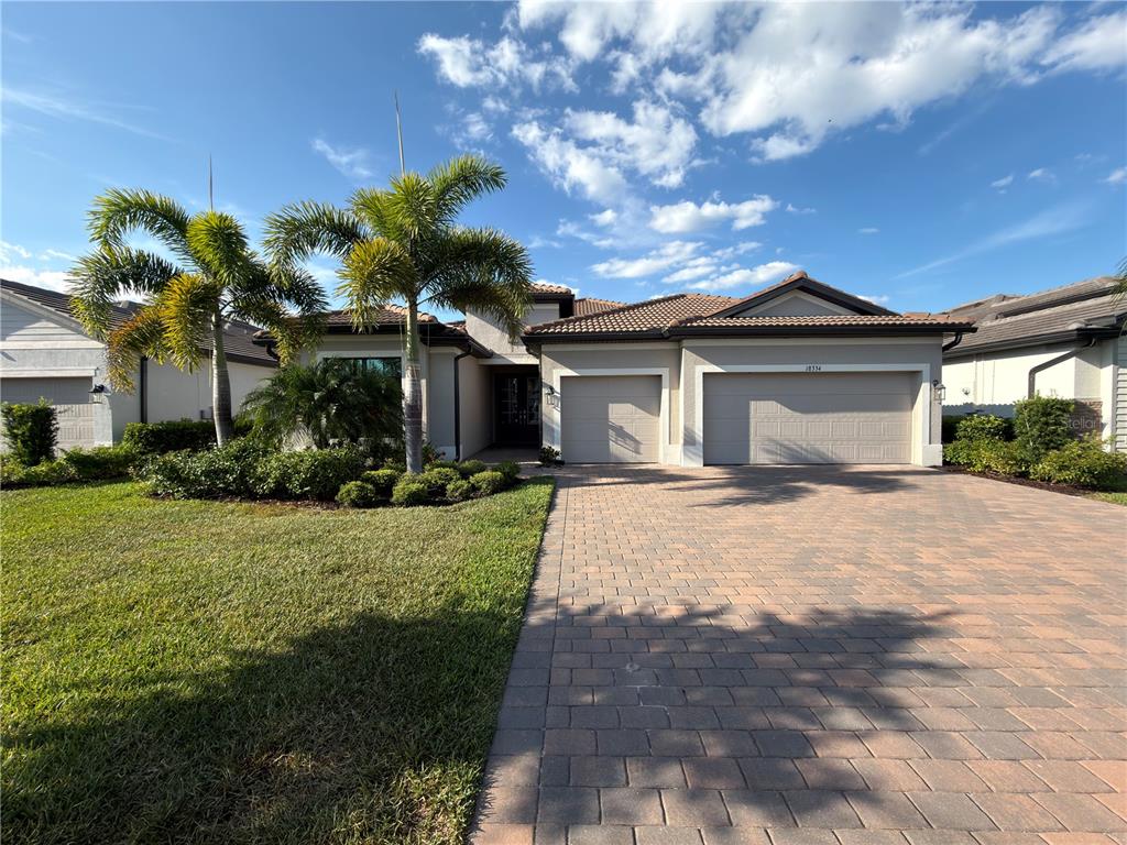 18334 Ridgeline Drive Estero, FL 33928 - Photo 3 of 30 a front view of a house with garden