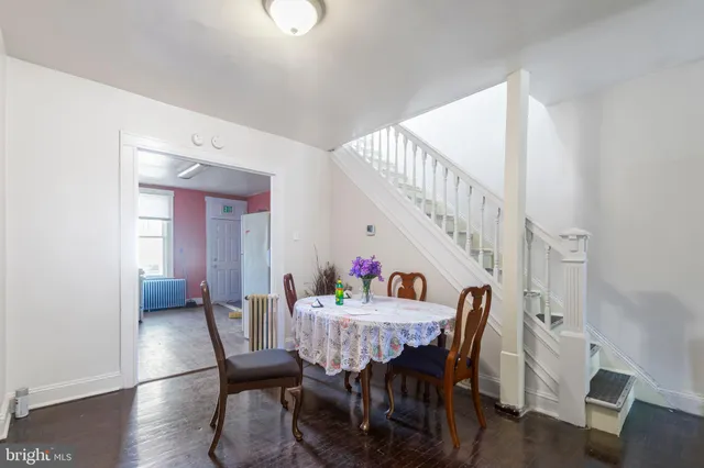 a kitchen with granite countertop a stove a sink and white cabinets