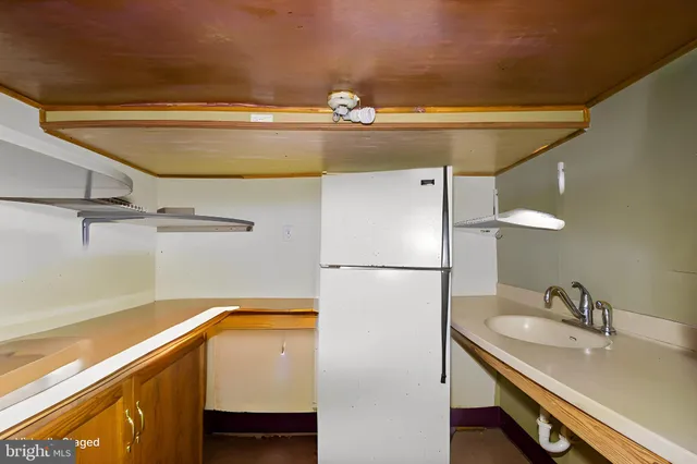 a view of a patio with table and chairs potted plants