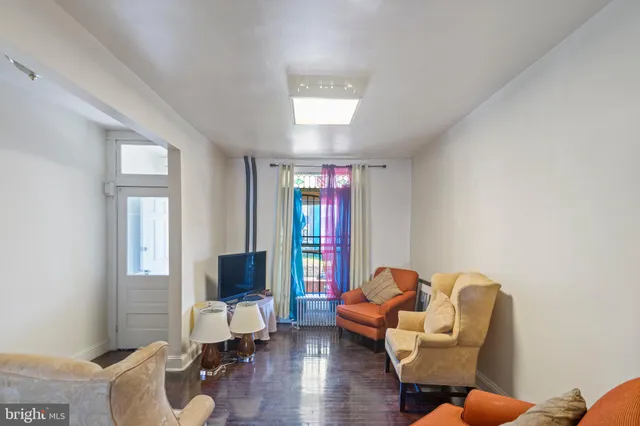 a dining room with furniture a rug and wooden floor