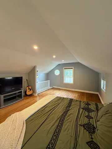 a bedroom with a bed and a window