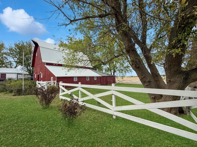 a view of backyard of house with green space