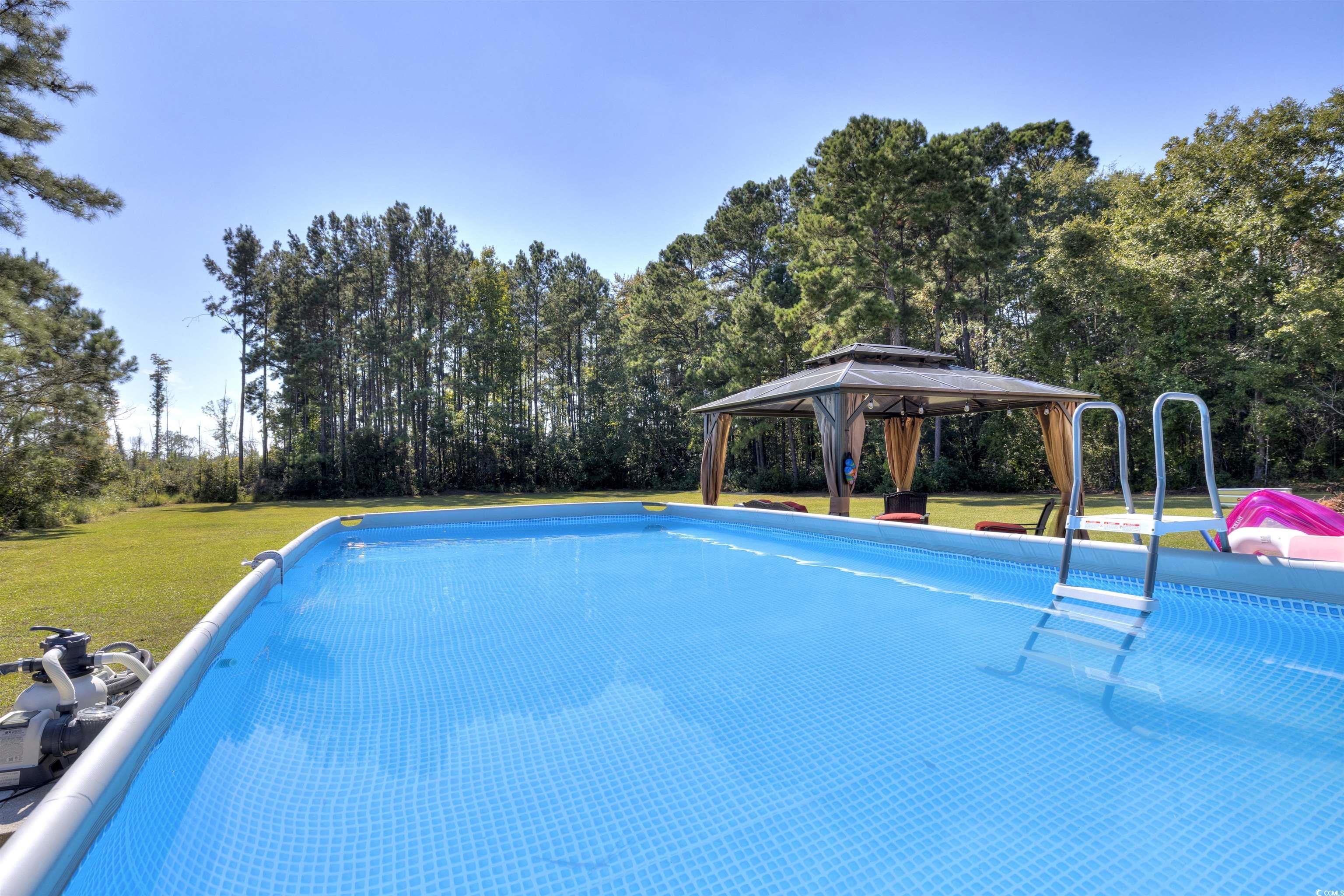 4520 Huggins Road Lake City, SC 29560 - Photo 8 of 40 View of swimming pool featuring a lawn and a gazebo