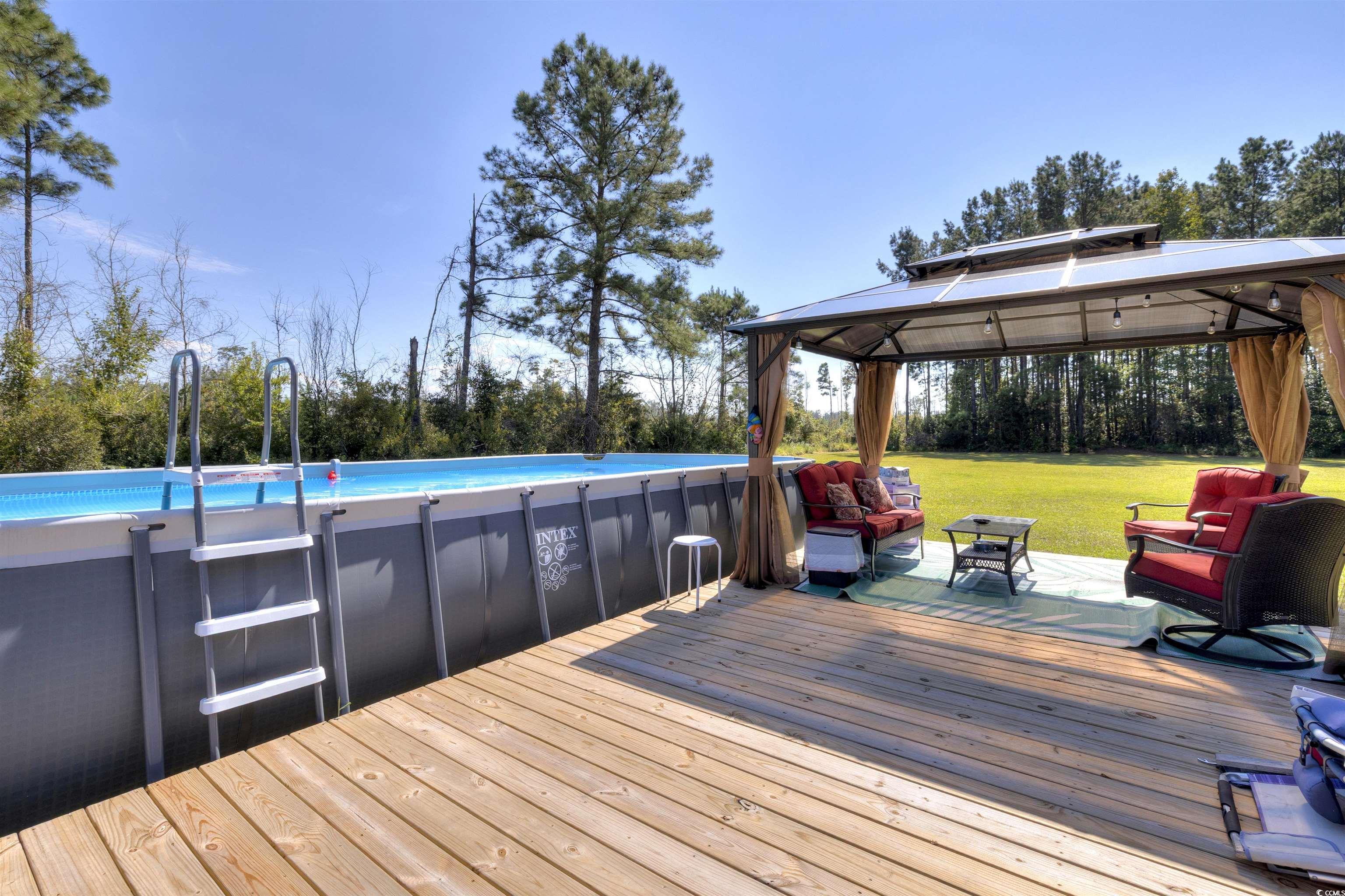 4520 Huggins Road Lake City, SC 29560 - Photo 9 of 40 Deck with an outdoor living space, a gazebo, and a yard