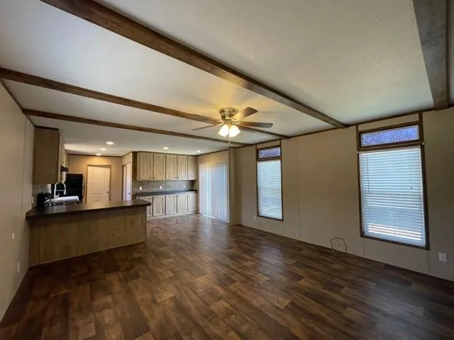 a view of a living room and kitchen with furniture wooden floor and window