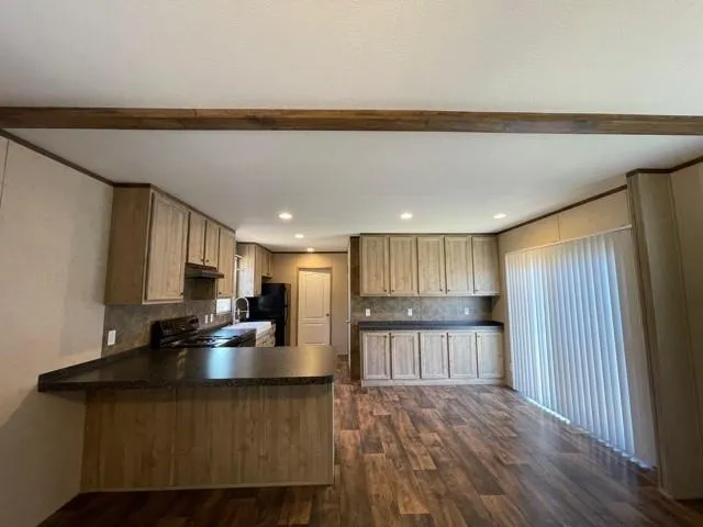 a kitchen with stainless steel appliances granite countertop a refrigerator sink and cabinets