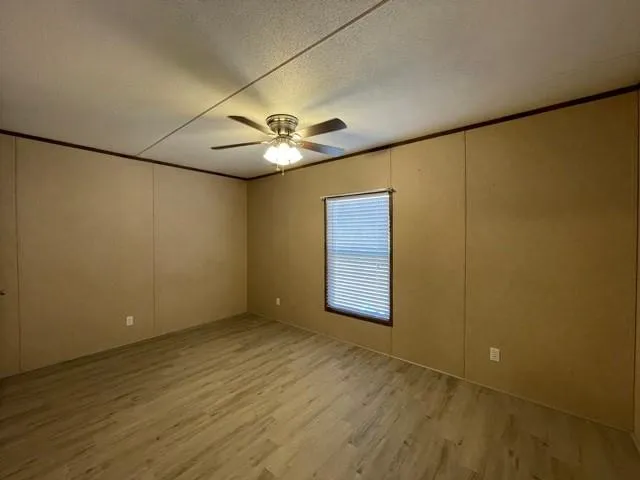 an empty room with a empty space and a ceiling fan