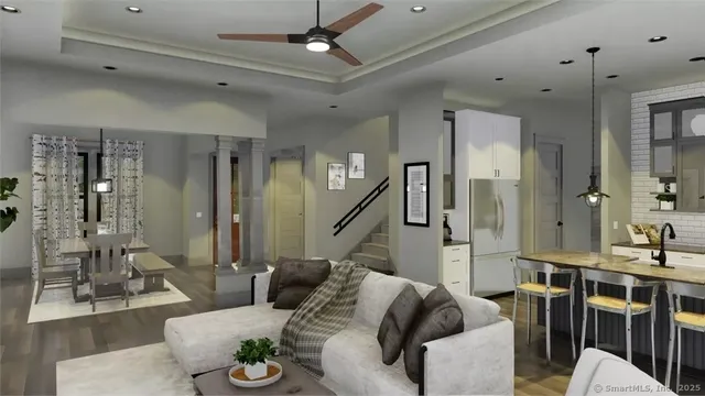 a living room with furniture and a chandelier