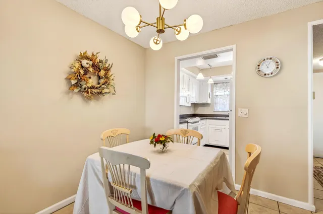 a view of a dining room with furniture and chandelier