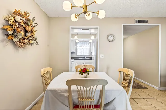 a view of a dining room with furniture and chandelier