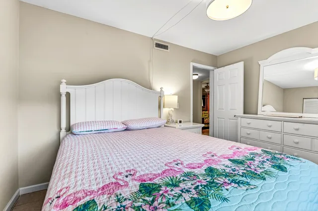 a bedroom with a bed and a dresser