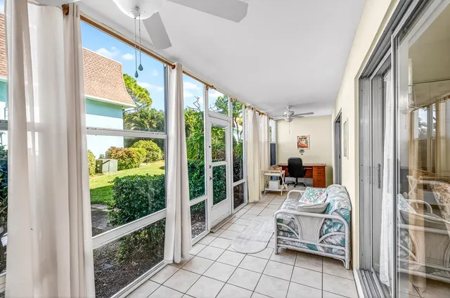 a living room with furniture and floor to ceiling windows