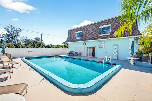 a view of a swimming pool with a lounge chairs