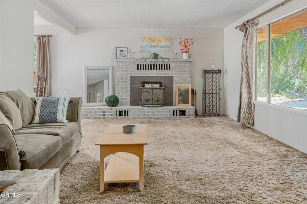 a living room with furniture a window and a fireplace