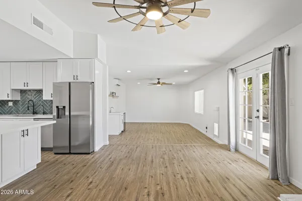 a view of a kitchen with a sink and wooden floor