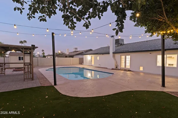 a view of a swimming pool with an outdoor space and seating area