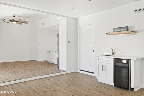 an empty room with a window and ceiling fan