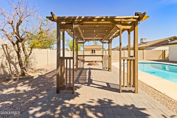 a view of a patio with swimming pool table and chairs