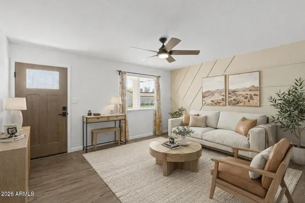 a living room with furniture and a view of kitchen