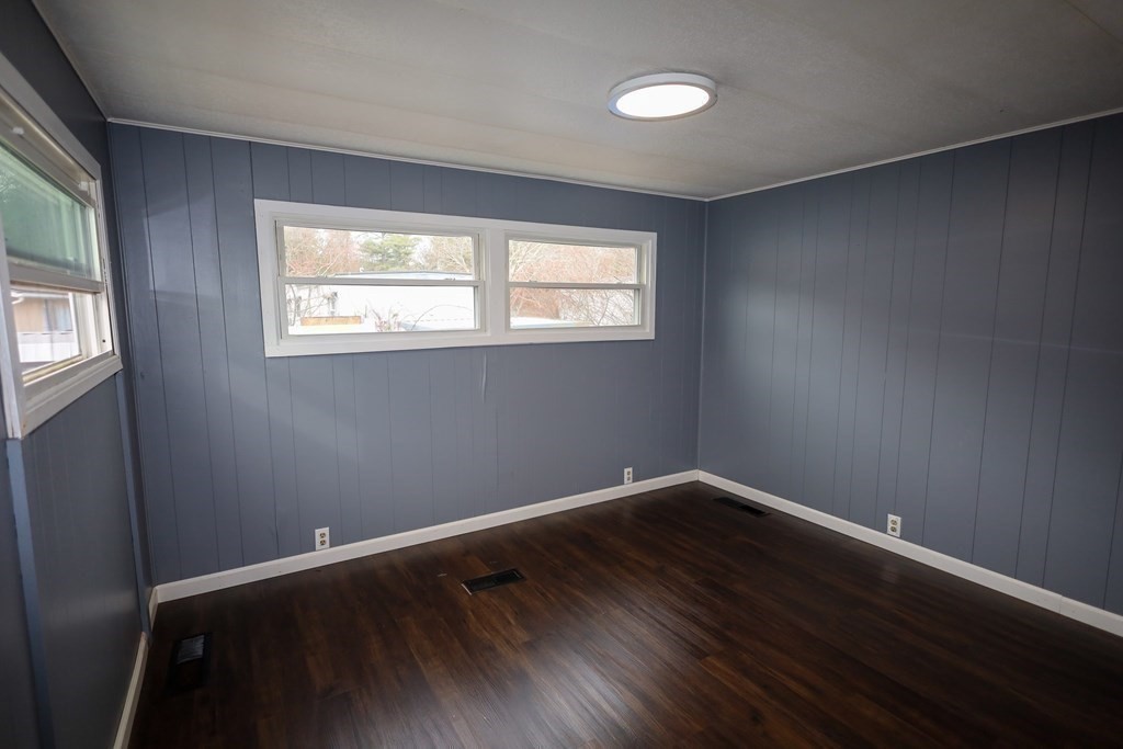 26 Claudia Street Wareham, MA 02538 - Photo 12 of 17 an empty room with wooden floor and windows