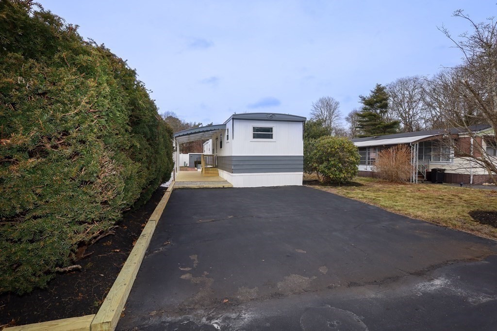 26 Claudia Street Wareham, MA 02538 - Photo 15 of 17 a front view of a house with a yard and garage