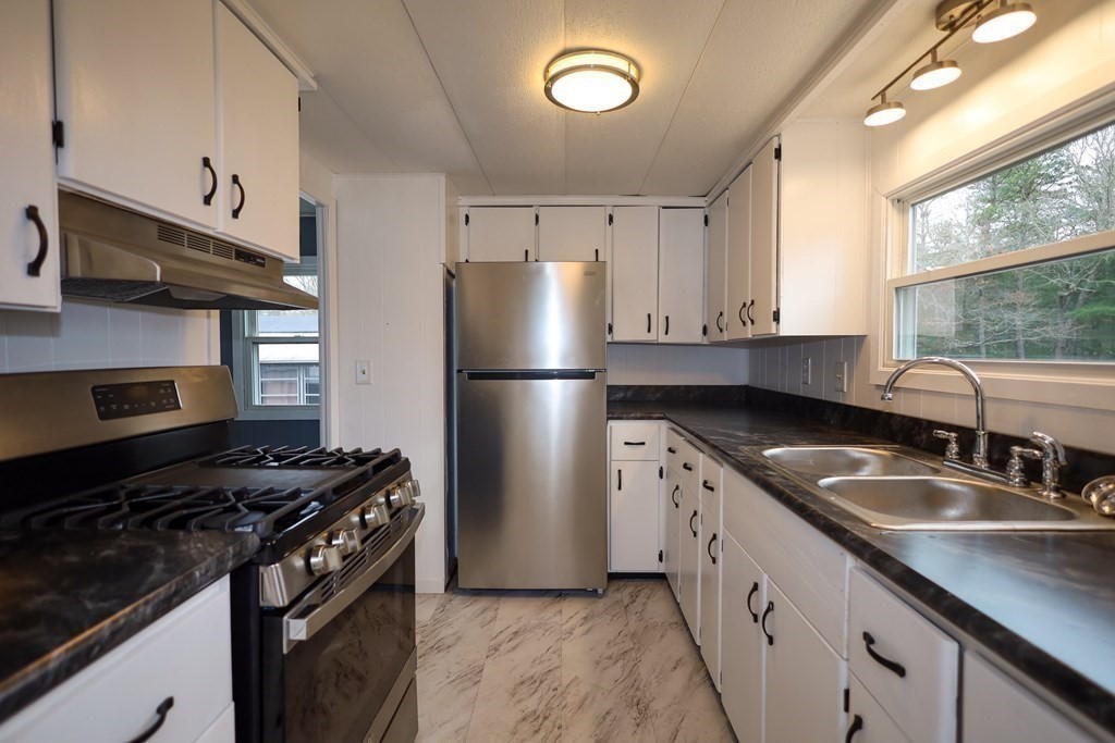 26 Claudia Street Wareham, MA 02538 - Photo 6 of 17 a kitchen with granite countertop a sink stove and refrigerator