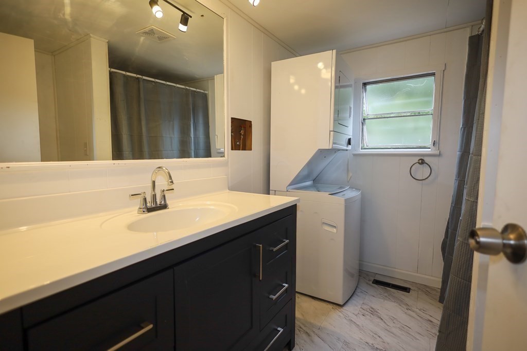 26 Claudia Street Wareham, MA 02538 - Photo 8 of 17 a en suite bathroom with a granite countertop sink and a mirror