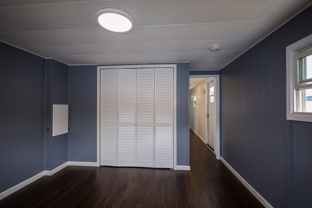 26 Claudia Street Wareham, MA 02538 - Photo 10 of 17 an empty room with wooden floor and windows