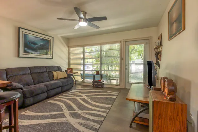 a living room with furniture and a floor to ceiling window