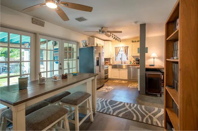 a kitchen with stainless steel appliances granite countertop a stove refrigerator and cabinets