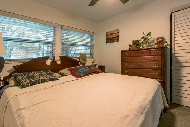 a bedroom with a bed and dresser with mirror