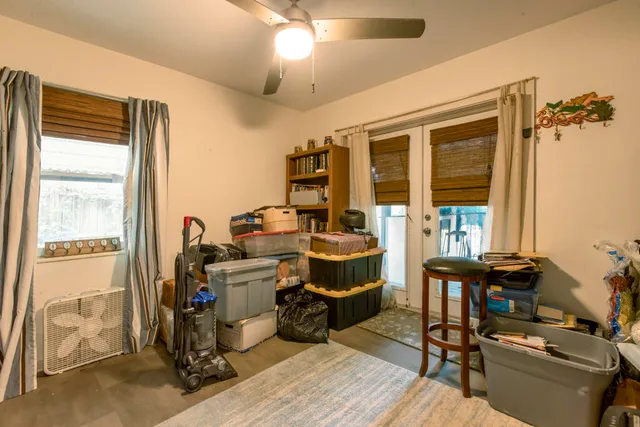 a view of a workspace with furniture and a window